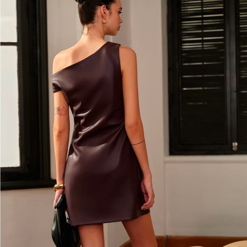 Asymmetrical cold shoulder dress. Faux leather